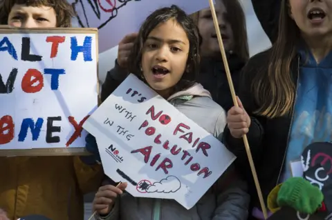 PA Media School children from Yerbury Primary School protest outside the High Court