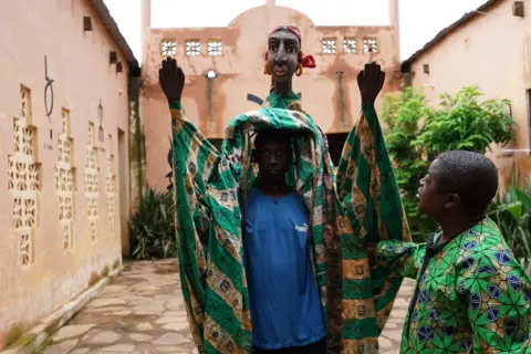 Clair MacDougall Man inside a puppet