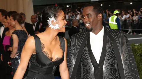 EPA Sean 'Diddy' Combs and Cassie arrives on the red carpet with Diddy wearing a black suit and Cassie a black dress