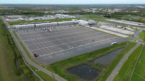 Getty An aerial picture shows freight trucks and heavy goods vehicles (HGVs) parked at the Sevington Inland Border Facility (Border Control Facility) located between the villages of Sevington and Mersham, near the M20 motorway near Ashford in Kent.