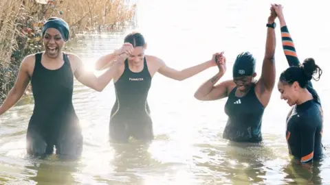 Rob Youngson Photography Four women in a lake. Left to right: Roni Bruno, Lexi Sandiford, Jasmine Boatswain and Alice Dearing. 
