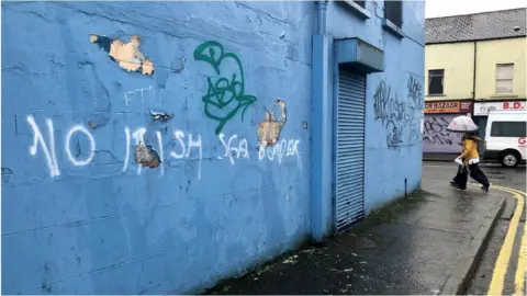 PA Media Graffiti saying no Irish Sea border