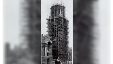 University of Bristol A black and white newspaper clipping of the Wills Memorial Building under constructions showing it wrapped in wooden scaffolding