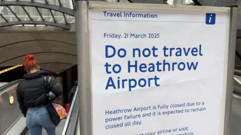 Sign at an underground station advising people not to travel to Heathrow Airport due to closure following a power failure 