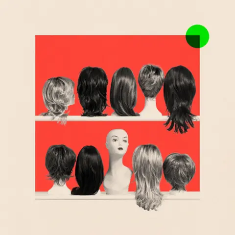 BBC A mannequin head sits on a shelf surrounded by rows of wigs, all facing away. The wigs vary in length and style.