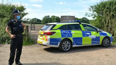 PA Media Police officer outside the farm