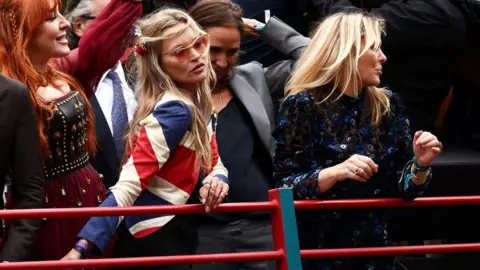 Reuters Kate Moss and Patsy Kensit on a 1990s bus in a parade during the Platinum Jubilee Pageant