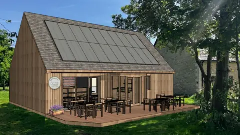 Kirtlington Community Shop & Cafe A computer generated image of a single storey wooden shop with solar panels on the sloping, tiled roof. Several tables and chairs are arranged on the decking in front of the shop's door and windows. 