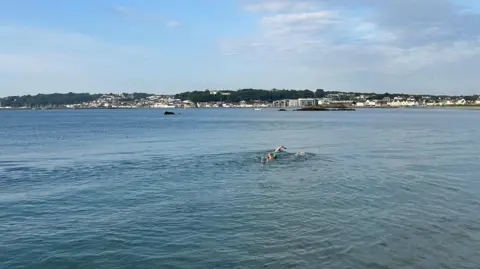 Swimmers with St Peter Port in the background