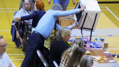 Cameron Noble Ballots being dropped onto a table