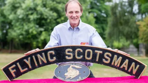 Jack Boskett Auctioneer with nameplate