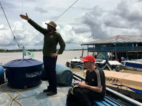 Guardian News and Media Dom Phillips, sitting, and Bruno Pereira on the Amazon in 2018