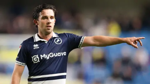 George Honeyman points during a match for Millwall