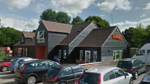 A google maps image of the Challengers play centre, a black weather-boarded building, and carpark in Stoke Park 