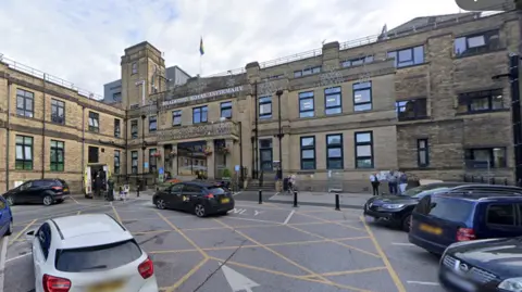 The entrance of Bradford Royal Infirmary with cars parked outside 
