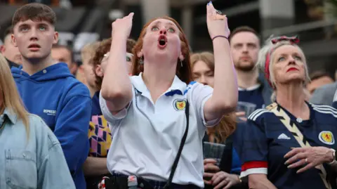 PA Media Scotland fans react during their defeat to Germany