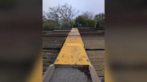 Joe Massey A picture of the unguarded rail crossing that children have to walk along en route to school