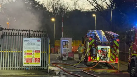 Leicester Media Online Two fire appliances with hoses running out into an area surrounded by metal fencing