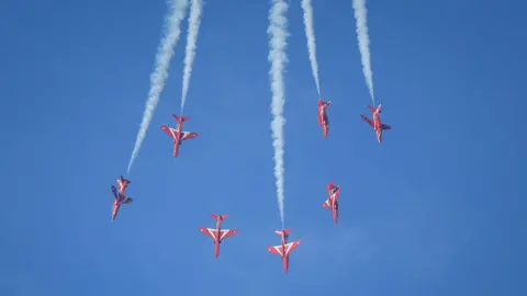 MANX SCENES Seven jets in formation heading downwards against a blue sky.