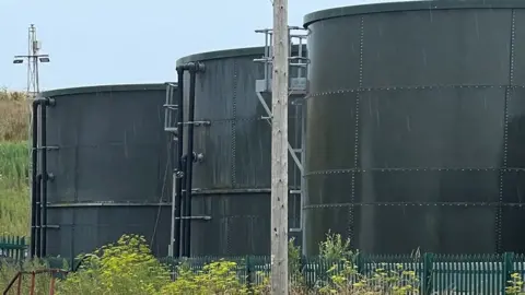 Three large cannisters at the waste site