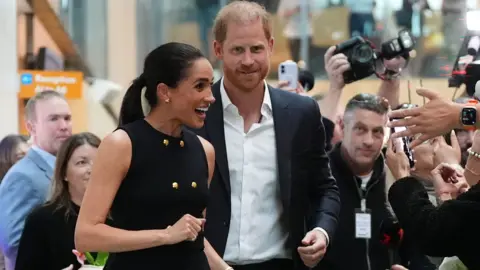 Harry and Meghan greet fans and press in Australia