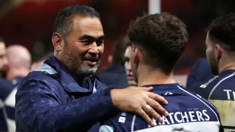 Pat Lam greets one of his players at the end of Bristol's win with Northampton.