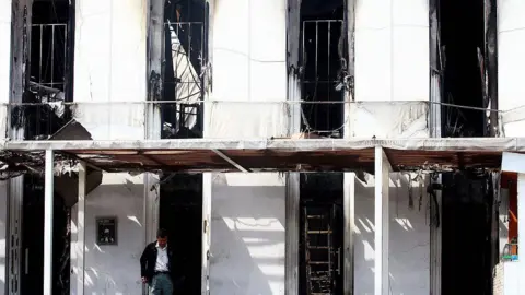 Getty Images A Thai investigator works at the burnt-out Santika nightclub in Bangkok on January 2, 2009.