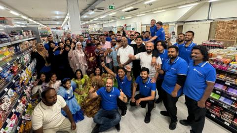 The Ipswich Bazaar team smile as they stand together in the new store