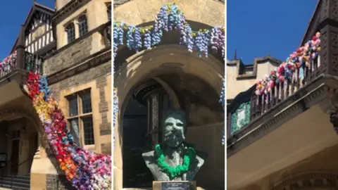 A composite image of flowers draped over a building and a statue.