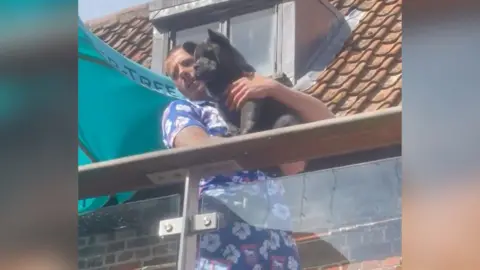 Emma Mildwater A still from a video of Teddy being carried by Harry Clarke