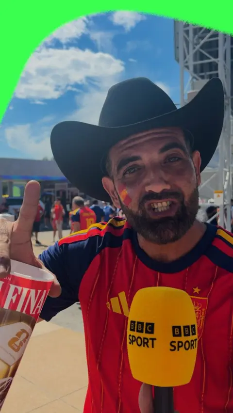 Spain fans hold bbc sport microphone