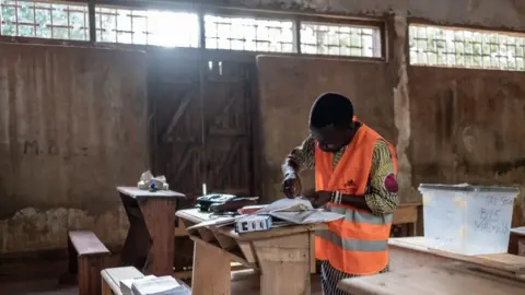 Barbara Debout/AFP Man setting up polling station in a high school in Bangui, Central African Republic on 30 July 2023.