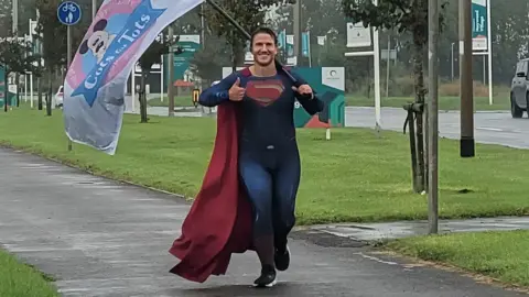 Thomas Young dressed as superman on one of his runs