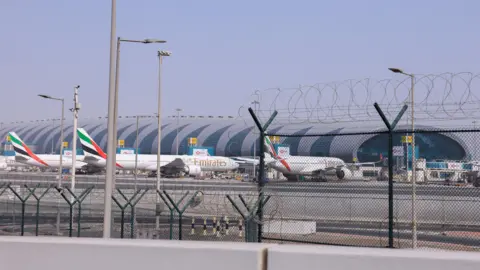 Reuters Planes parked at Terminal 3 of the Dubai International Airport, following the United States and Israel strikes on Iran, in Dubai