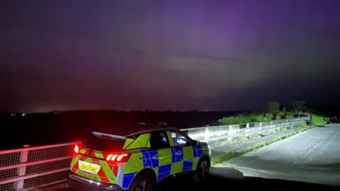 Cambs Police Police car and Northern Lights