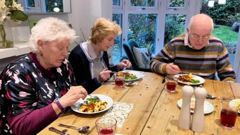Three clients sharing lunch together