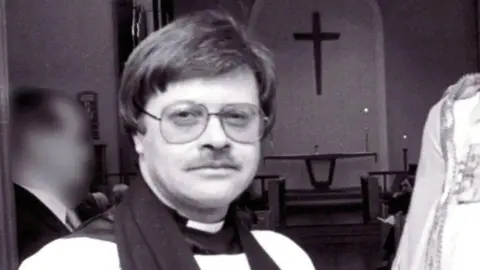 AFP A black and white photograph of the late Reverend Trevor Devamanikkam