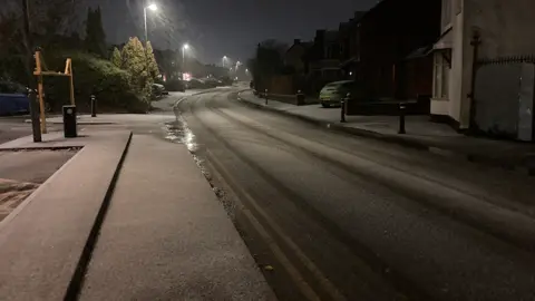 Snow on a dark street at evening