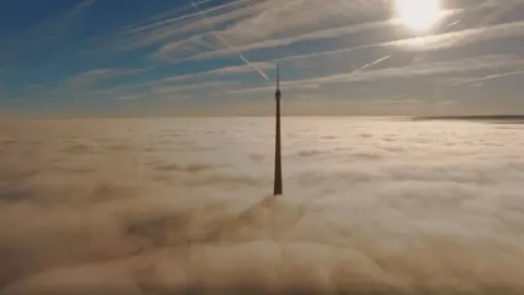 Ed Midgley Top of Emley Moor Mast above cloud