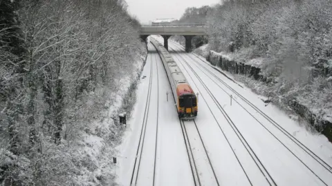 PA Media Snow covered tracks near Surbiton Station