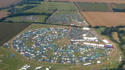 Essex Scouts Aerial view of the event in 2012, shows tents and cars arranged within a circular perimeter on a field.