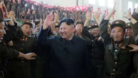 AFP This picture taken on 4 July, 2017 shows North Korean leader Kim Jong-Un celebrating the successful test-fire of an intercontinental ballistic missile