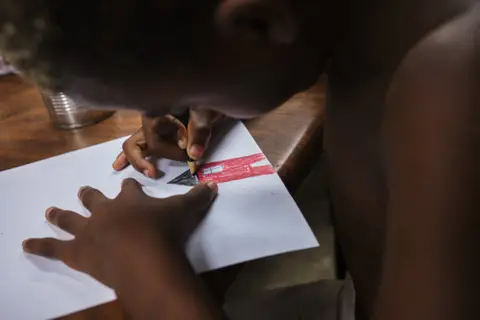 Natalia Favre Eyko draws a house during an art workshop cultural centre, in Havana, Cuba, on September 17, 2022. Eyko attends these twice a week.