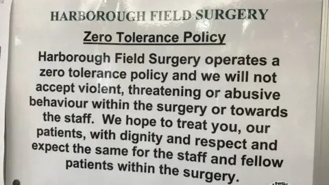 A zero tolerance sign in a doctors surgery