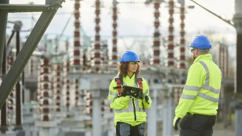 Getty Images Workers at electricity substation