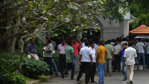 AFP Supporters have gathered outside Mr Wickramasinghe's residence