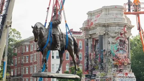 Getty Images A statue of Confederate General Robert E. Lee being removed by authorities in September.