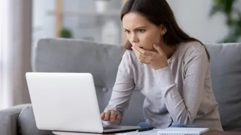 Getty Images Woman reading laptop