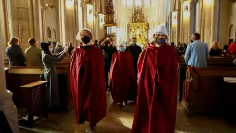 Reuters Protesters walk through a cathedral in Lodz, Poland