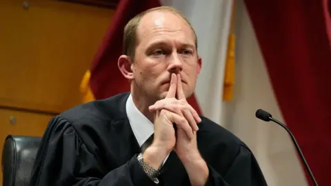 Getty Images Judge Scott McAfee presides over a hearing into 'misconduct' allegations against Fulton County District Attorney Fani Willis